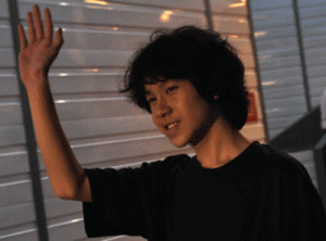 Amos Yee, 16, waves to the media as he leaves the state court in Singapore on Tuesday. AFP PHOTO