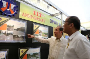 NEW FAVORITE President Benigno Aquino 3rd views pictures of a public infrastructure project that was highlighted in the 117th anniversary of the DPWH. With him is Public Works Secretary Rogelio Singson. MALACAÑANG PHOTO 