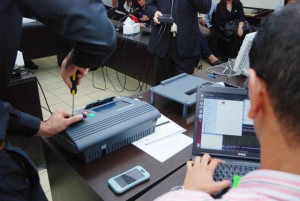 UPGRADED Smartmatic representatives demonstrate how a dual storage PCOS machine works.  CONTRIBUTED PHOTO 