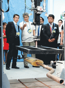 DOST Assistant Secretary Roberto Dizon (left) briefs Department of Trade and Industry Undersecretary Adrian Cristobal (center) during a site tour of the Auto-Parts testing facility in Taguig.