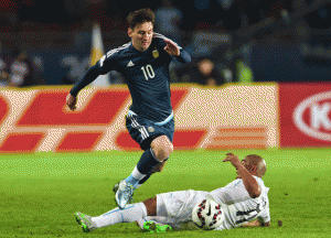 Argentina’s forward Lionel Messi (top) and Uruguay’s midfielder Egidio Arevalo Rios vie for the ball during their 2015 Copa America football championship match, in La Serena, Chile, on Wednesday.  AFP PHOTO