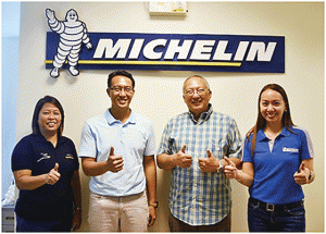 Michelin Right2Race 2014 winner Ivan Isada (2nd from left) together with his father, Vip, flashes the thumbs-up sign prior to their departure for France to watch the Le Mans 24 Hours. Together in photo are Michelin marketing and communications manager, Caroline del Rosario (right) and Michelin human resources manager Genebeth Potenciano. 