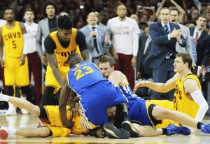 Draymond Green No.23 and David Lee No.10 of the Golden State Warriors fall on top of Matthew Dellavedova No.8 of the Cleveland Cavaliers in the fourth quarter during Game Three of the 2015 NBA Finals at Quicken Loans Arena on Wednesday in Cleveland, Ohio. AFP PHOTO