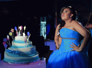 Claudia Itzel poses next to her cake during her 15-year anniversary celebration party in Mexico City. Despite criticism that they are patriarchal, outdated and kitsch, these 