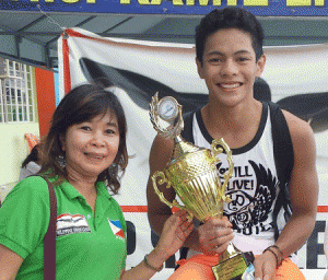 President’s Trophy winner Sean Elijah Enero with Philippine Swimming League Secretary General Maria Susan Benasa. CONTRIBUTED PHOTO