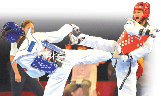 Pauline Louise Lopez of the Philippines (right) competes against Thi Thu Hien Pham of Vietnam during the women’s under 57kg taekwondo final at the 28th Southeast Asian Games (SEA Games) in Singapore. Lopez won the gold. AFP PHOTO
