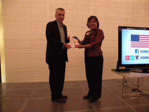 Atty. Angie Umbac of the Rainbow Rights Project hands over a copy of the US-funded handbook on inclusive workplaces for the LGBT community to the ambassador, which was also launched during the reception