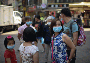 BRAVING MERS A family of tourists wearing facemasks stand on a street in the Myeongdong shopping area in Seoul on June 4, 2015. AFP PHOTO