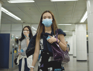 MERS SCARE  SEOUL: A woman wearing a facemask walks through a subway station in Seoul on June 2, 2015. South Korea’s health ministry confirmed that two people have died from Middle East Respiratory Syndrome (MERS), the country’s first fatalities from the virus. AFP PHOTO