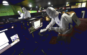 NO END IN SIGHT FOR OUTBREAK South Korean workers wearing protective gear disinfect computers at an Internet cafe in Seoul on June 16, 2015. South Korea on June 16 reported three more fatalities from MERS, taking the country’s death toll from the outbreak to 19 as four new cases were confirmed, the health ministry said. AFP PHOTO