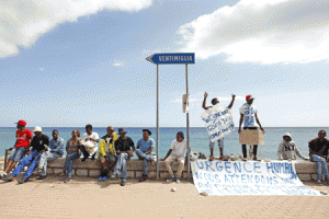 IN LIMBO  Migrants hold placards reading “we are not going back”, “humanitarian emergency, we are waiting for a political answer from Europe now”, as they wait near the sea, in the city of Ventimiglia at the French-Italian border, on June, 15, 2015. French border police told AFP they had been ordered not to let through the migrants, many of whom came from Somalia, Eritrea, the Ivory Coast and Sudan, and hoped to travel onwards to Germany, Britain or Sweden to request asylum. AFP PHOTO