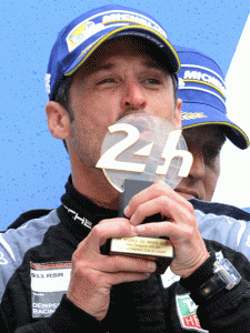 US Patrick Dempsey kisses his trophy on the podium the 83rd Le Mans 24 Hours endurance race on Sunday in Le Mans, western France, after taking second place in the LMGTE-Am category with his Porsche 911 RSR N°77. AFP PHOTO