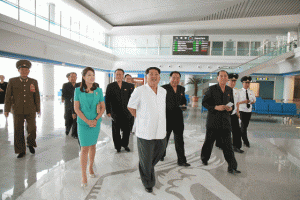 NEW AIRPORT  This picture taken and released from North Korea’s official Korean Central News Agency (KCNA) on June 25, 2015 shows North Korean leader Kim Jong- n (C), accompanied by his wife Ri Sol-Ju (front L), inspecting the new terminal at Pyongyang International Airport which was recently successfully completed. North Korea’s showcase new airport terminal, which had to be partly demolished and rebuilt at leader Kim Jong-Un’s him, is to open on July 1, state media said on June 25. AFP PHOTO