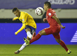 Brazil’s forward Neymar (left) kicks the ball marked by Peru’s midfielder Joel Sanchez during their 2015 Copa America football championship match in Temuco, Chile on Sunday. AFP PHOTO