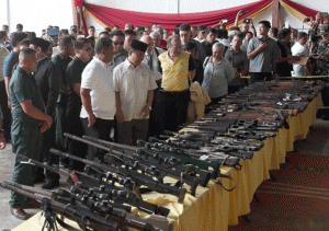 BUCK FOR A BANG  President Benigno Aquino 3rd (center) views the guns handed over for decommissioning by the Moro Islamic Liberation Front on Tuesday in Sultan Kudarat. PHOTO BY RENE DILAN