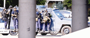 TEXAS SHOOT-OUT The Dallas Police SWAT team rolls through the scene as a gunman calling himself James Boulware was in a standoff in a fast food parking lot before being killed by a sniper shot.  Getty Images/AFP