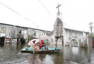 GENTLY DOWN THE STREAM  Storm or no storm, residents of Artex Compound in Barangay Panghulo in Malabon City use paddle boats in getting around. The community has endured year-round flooding for more than a decade. PHOTO BY RENE H. DILAN 