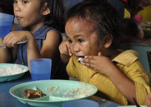 FEEDING OF THE INNOCENTS  Children partake of free meals provided by the World Mission Community at the Baseco compound in Manila.  PHOTO BY BONG RANES