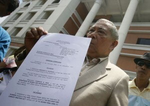 A BAD DAY FOR BUTCH  Lawyer Bonifacio Alentajan shows a copy of his complaint against Budget Secretary Florencio Abad. PHOTO BY MIGUEL DE GUZMAN 