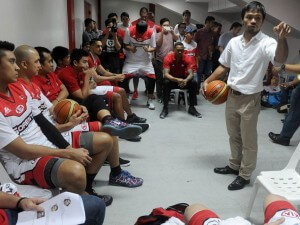 World boxing champion Manny Pacquiao (right) gives a pep talk to a Philippine professional basketball team where he serves as playing coach before a game in Manila. AFP FILE PHOTO