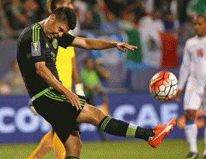 Oribe Peralta No.19 of Mexico kicks the ball after scoring a goal against Cuba during a match in the 2015 CONCACAF Gold Cup at Soldier Field on Friday in Chicago, Illinois.  AFP PHOTO