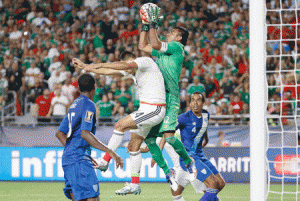 Goalkeeper Paulo Motta No.12 of Guatemala makes a leaping save over Javier Hernandez No.14 of Mexico during the final moments of the 2015 CONCACAF Gold Cup group C match at University of Phoenix Stadium on Monday in Glendale, Arizona. AFP PHOTO