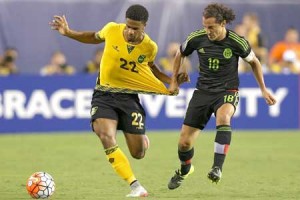 Garath McClearly No.22 of Jamaica battles for the ball with Andres Guardado No.18 of Mexico in the in the first half during the CONCACAF Gold Cup Final at Lincoln Financial Field on Monday in Philadelphia, Pennsylvania. AFP PHOTO