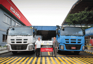 IPC president Hajime Koso (right) and EVP Takashi Tomita pose beside the new trucks.