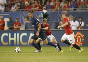 Paris Saint-Germain forward Zlatan Ibrahimovic, (left) controls the ball against Manchester United defender Luke Shaw (center) and defender Bastian Schweinsteiger during the second half of their International Champions Cup soccer game at Soldier Field in Chicago, Illinois on Thursday. AFP PHOTO