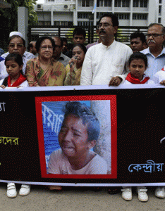 OUTRAGE  Bangladeshi protesters carry a banner during a demonstration against the lynching of a 13-year-old boy in Dhaka on July 14, 2015. Outrage over the lynching of a 13-year-old boy mounted in Bangladesh, with more protests over the murder which was captured on video, as one of the suspects confessed after being arrested in Saudi Arabia. Bangladeshi police have now arrested five people over the July 8 killing of Samiul Alam Rajon, who was tied to a pole and then subjected to a sickening assault in which he pleaded for his life. AFP PHOTO