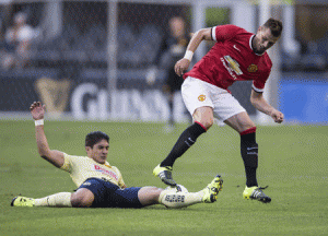 Javier Guemez (left) of Club America tackles Manchester United’s Morgan Schneiderlin in a the first half of their International Champions Cup match on Saturday in Seattle, Washington. AFP PHOTO