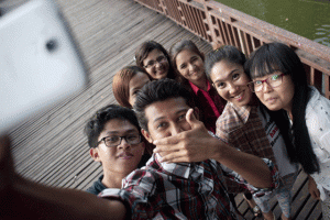 SELFIES FOR PEACE In this picture taken on June 18, 2015, campaigners from different religions and ethnic groups pose for a selfie at the KanDawGyi Lake in Yangon. In a nation where religion and ethnicity are incendiary issues, a selfie campaign by Myanmar students promoting cross-cultural friendships has become a rare counterpoint to bilious anti-Muslim rhetoric from hardline Buddhist monks. AFP PHOTO 