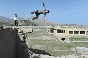 An Afghan youth practices his parkour skills behind the ruins of Darul Aman Palace in Kabul. Parkour, which originated in France in the 1990s and is also known as free-running, involves getting around urban obstacles with a fast-paced mix of jumping, vaulting, running and rolling. AFP PHOTO