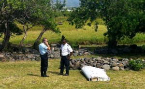 POSSIBLE CLUE   A policeman and a gendarme stand next to a piece of debris from an unidentified aircraft found in the coastal area of Saint-Andre de la Reunion, in the east of the French Indian Ocean island of La Reunion, on July 29, 2015. The two-meter-long debris, which appears to be a piece of a wing, was found by employees of an association cleaning the area and handed over to the air transport brigade of the French gendarmerie (BGTA), who have opened an investigation. An air safety expert did not exclude it could be a part of the Malaysia Airlines flight MH370, which went missing in the Indian Ocean on March 8, 2014. AFP PHOTO 