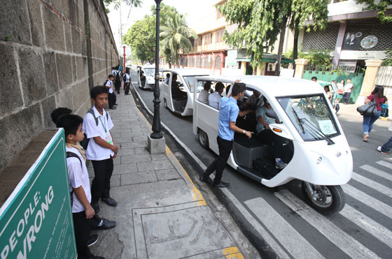 Electronic tricycles pick up passengers along the so-called Walled City of Intramuros, Manila. The environment-friendly shuttle will start rolling out this week and will be free of charge for two months. PHOTO BY RENE H. DILAN 