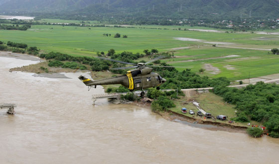  An air force helicopter flying past a destroyed bridge in Ilocos Sur  a day after typhoon Ineng hit the province over the weekend. AFP PHOTO / PHILIPPINE AIR FORCE