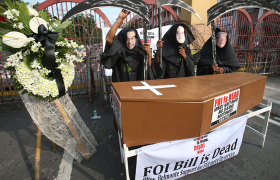 Protesters dressed as the Grim Reaper poses before a coffin that symbolizes the death of the Freedom of Information Bill during a rally at the foot of the Mendiola Bridge in Manila on Wednesday. PHOTO BY RENE H. DILAN 