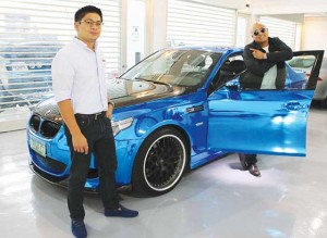 Jan Vincent Marcelo (left), chief financial officer of Foilacar Industries, and Lester Codog pose beside a BMW M5 that was given a full wrapping of shiny blue foil that will definitely make it a head-turner in the streets of Metro Manila.