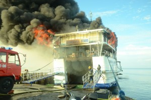 Firemen pour water on the fire of the ill-fated ship MV Wonderful Stars that went ablaze after docking at the local port in Ormoc Port on Saturday morning. PHOTOS BY ROBERT DEJON