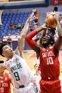 Nigerian Ola Adeogun rams through the defense of Saint Bernilde Blazers to score a basket during a National Collegiate Athletic Association men’s basketball game on Friday at The Arena in San Juan City. PHOTO BY OSWALD LAVINA 