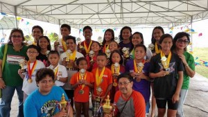 Philippine Swimming League President Susan Papa and Secretary General Maria Susan Benasa with the Most Outstanding Swimmer awardees and champion team coaches.