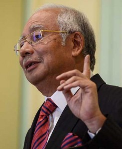 DOGGED BY SCANDAL  This file picture taken on August 14 shows Malaysia’s Prime Minister Najib Razak speaking during a press conference at his office in Putrajaya. Thousands of protesters plan to demand Najib’s ouster at a demonstration in Kuala Lumpur on August 30, putting them on a potential collision course with police. AFP PHOTO
