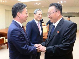 TENSIONS REDUCED  This handout photo released by the presidential Blue House shows the South Korean Unification Minister Hong Yong-Pyo (L) shaking hands with North Korean top official in charge of South Korea affairs, Kim Yang-Gon (R), as South Korean president’s national security adviser, Kim Kwan-Jin (C), looking on during their last meeting after days of intensive high-level talks at the truce village of Panmunjom in the Demilitarized Zone (DMZ) dividing the two Koreas on August 25. North and South Korea wrapped up marathon talks on August 25 with an agreement aimed at defusing a crisis that had pushed the two rivals to the brink of armed conflict. AFP PHOTO