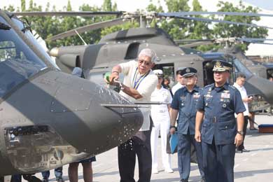 Defense Secretary Voltaire Gazmin pours champagne on the nose of a Bell 412 helicopter, one of 10 choppers acquired by the military for its modernization program. PHOTO BY RENE H. DILAN