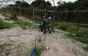 WATCH YOUR STEP  This handout photo taken on August 9 by the South Korean Defense Ministry shows South Korean soldiers inspecting the scene where planted landmines exploded on August 4, maiming two soldiers on border patrol in the demilitarized zone dividing the two Koreas in Paju. South Korea accused North Korea of planting the landmines, sending military tensions on the Korean peninsula soaring as it threatened to make Pyongyang pay a “harsh price.” AFP PHOTO