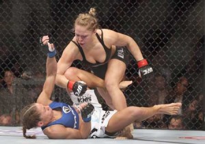 Ronda Rousey hits Liz Carmouche during their UFC Bantamweight Title fight at Honda Center on February 23, 2013 in Anaheim, California. AFP FILE PHOTO