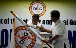  IN AND OUT Mel Senen Sarmiento (left) receives the flag of the Department of the Interior and Local Government from outgoing secretary Manuel Roxas 2nd. photo by Miguel de Guzman 