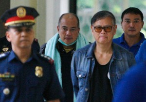 GOTCHA Brothers Joel and Mario Reyes are escorted into the Camp Crame conference room where they were presented to the media following their deportation from Thailand. PHOTO BY MIGUEL DE GUZMAN