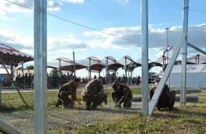 RAISING THE BARRIER  Hungarian soldiers raise a fence at the Croatian-Hungarian border between the villages of Baranjsko Petrovo Selo, Croatia and Beremend, Hungary on September 21. The fence system including chicken wire and barbed wire is in place at the border area to close the official border crossing in village of Beremend, thus preventing further influx of Middle-Eastern migrants into Hungary. AFP PHOTO