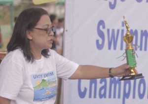 PSL Board Member Maria Teresa Mahiwo, awards trophy to the winners of the recent PSL leg series. CONTRIBUTED PHOTO